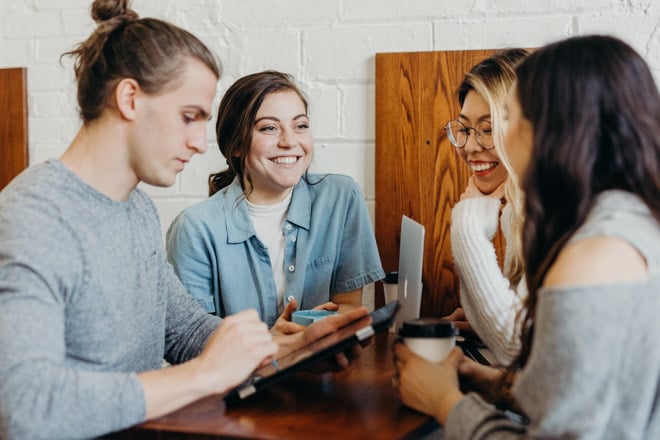 group of young people working around table