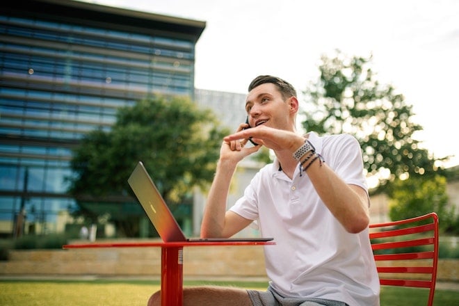 busy entrepreneur talking on the phone while working outside