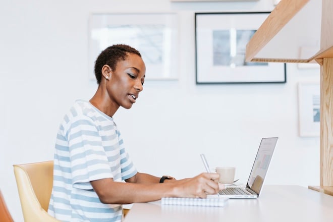 female entrepreneur taking notes off a computer