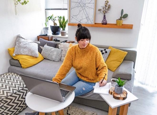 woman working on her foreign qualification on laptop at home